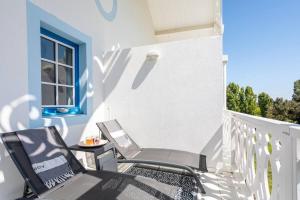 two chairs and a table on a balcony at La Terrasse du Golf in Talmont
