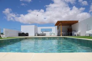 a swimming pool in front of a house at Fuerte Roche 1 in Tuineje