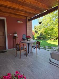 a patio with a table and chairs on a patio at B&B Rubino in Cuneo