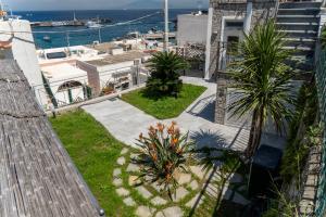 an overhead view of a garden with palm trees and the ocean at La Tranquilla Apartment in Capri