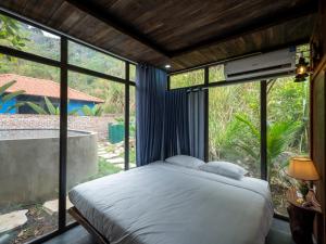 sypialnia z łóżkiem przed oknem w obiekcie Trang An Mountain Resort w mieście Ninh Binh