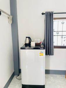 a small refrigerator with a tea kettle on top of it at Piang Dao Classic resort in Chiang Dao +16 photos
