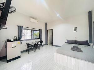 a bedroom with a bed and a table and chairs at Piang Dao Classic resort in Chiang Dao