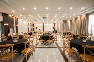 a banquet hall with tables and chairs in a room at Snooze Inn & Suites in Davao City