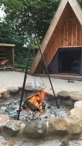 a fire in front of a building with a tent at Granngården in Fåborg