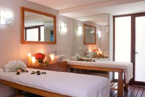 two beds in a room with a mirror at Casa del Alma Hotel Boutique & Spa in San Cristóbal de Las Casas
