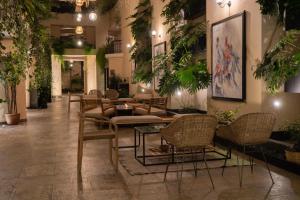 a lobby with chairs and tables and plants at Casa del Alma Hotel Boutique & Spa in San Cristóbal de Las Casas