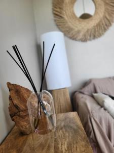 a glass vase sitting on a table in a living room at La Terrasse du Golf in Talmont +24 photos