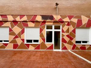 a mural on the side of a building with windows at Hostel VAM Torrejón in Torrejón de Ardoz