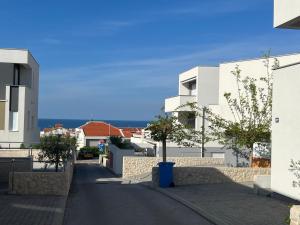 a street in a town with white buildings at Anabella apartment - Jacuzzi & Infra Sauna in Novalja