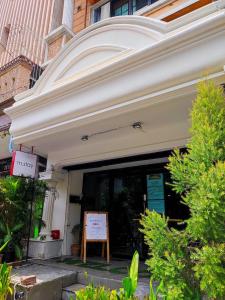 a white building with a sign in front of it at mstay in Bangkok +160 photos