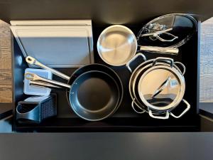 a box with a pot and pans and a mirror at VILLAREJA - Private City Suite im Herzen der Bozner Altstadt in Bolzano