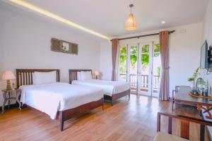 Ein Bett oder Betten in einem Zimmer der Unterkunft Ancient Garden Boutique Hoi An