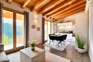 a kitchen and living room with a table and chairs at Apartment Monti e Lago - Tignale in Tignale