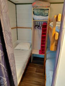 a small room with two bunk beds in it at Petit chalet 5 personnes in La Celle-sous-Gouzon +11 photos