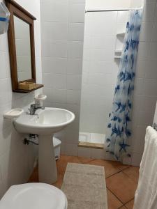 a bathroom with a sink and a toilet and a shower at Hotel Giglio in Lampedusa