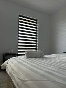 a white bedroom with a large bed and a window at LiAn House in Corbeni +33 photos
