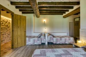 Postel nebo postele na pokoji v ubytování Casa rural Mas Plantalech