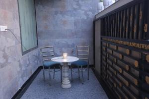 a table and two chairs with a candle on it at Royal Taj Twin Palace near Taj Mahal in Agra