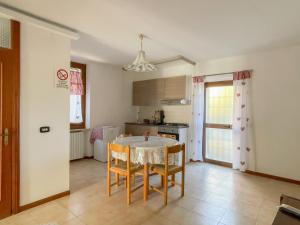 a kitchen with a table and chairs in a room at Flowers & Angels Home in Santa Maria degli Angeli
