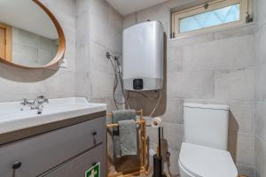a bathroom with a toilet and a sink and a mirror at Oásis à beira mar in Sesimbra +18 photos