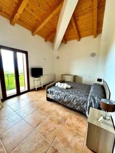 a bedroom with a bed and a tv in a room at Casa Micia Spilinga in Spilinga