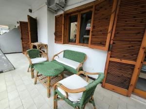 a patio with two chairs and a table and chairs at ScaLOVEa in Scalea