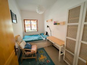 a bedroom with a desk and a bed and a table at ScaLOVEa in Scalea