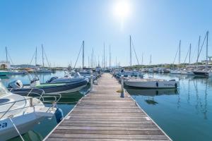 a dock with many boats docked in the water at Tilly by DomusAway in Olbia