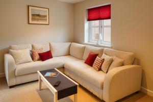 a living room with a couch and a table at Elegant 2BD Townhouse in Thirsk: Cozy & Stylish in Thirsk