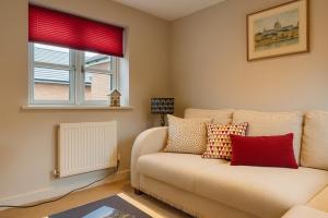 a living room with a couch and a window at Elegant 2BD Townhouse in Thirsk: Cozy & Stylish in Thirsk