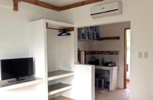 a living room with a tv and a refrigerator at Lanterna Hotel Boracay in Boracay