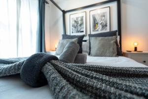 a bedroom with a bed with a blanket on it at Ultra Modern Studio Apartment, in Central Exeter in Exeter
