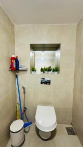 a bathroom with a white toilet and a mirror at Le Plaisir at Lodha Belmondo 2 mins walk to Golf in Dehu Road