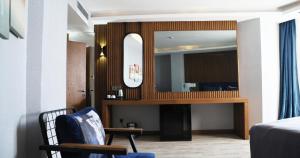 a living room with a mirror and a chair at Elite World Resort Mersin Silifke in Silifke
