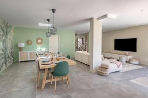 una sala da pranzo e un soggiorno con tavolo e sedie di 850m de la mer - Maison 8 adultes et 4 enfants a Piriac-sur-Mer