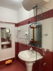 a bathroom with a sink and a mirror at Aron’s House in Krujë +35 photos
