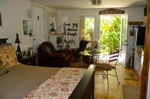 a bedroom with a bed and a living room at Magnolia Petal in Ganges