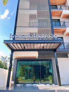 a building with a sign on the side of it at Ozone hotel khanom in Khanom