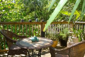 a table and chairs on a patio with a fence at Magnolia Petal in Ganges