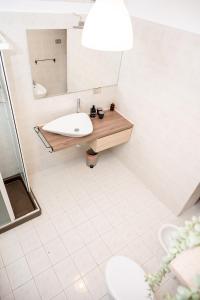 a bathroom with a sink and a mirror at Sognando Varenna-Lake Como View- in Fiumelatte +15 photos