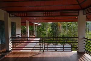 a view from the inside of a building with a balcony at The Calm County Homestay in Mānantoddy