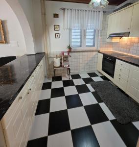 a kitchen with a black and white checkered floor at Holiday Home Marković in Bibinje +53 photos