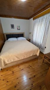 een slaapkamer met een groot bed met een raam bij Kalliopi House For 6 - Keros Beach in Kalliópi +27 foto's