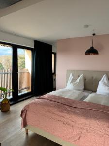 a bedroom with a large bed and a balcony at Penthouse in Buttelstedt +28 photos