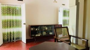 a dining room with a cabinet full of wine glasses at The Old Manor - Weligama in Weligama