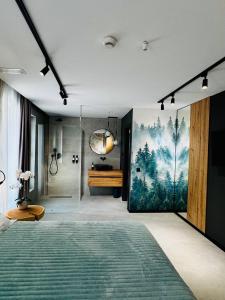 a bedroom with a large painting on the wall at MAPaMONT in Văliug