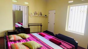 a bedroom with two beds and a large window at The Old Manor - Weligama in Weligama