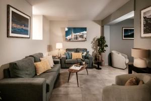 a living room with two couches and a table at The Howard Hotel in Sliema