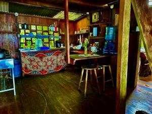 a bar with a counter and stools in a room at Shared Beach House in Drake
